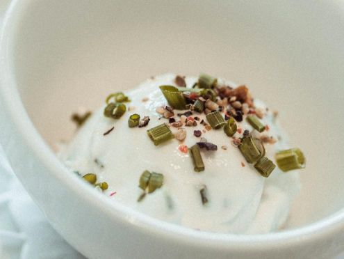 Quark dish decorated with nuts and herbs
