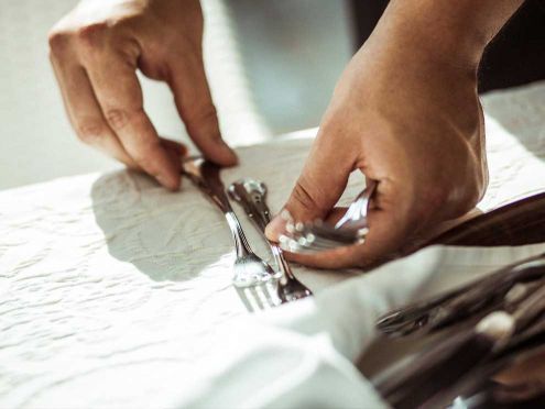 Waiter setting a table at the Limmerhof Restaurant